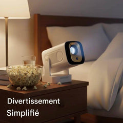 Douchity - Projecteur Pro Max on bedside table with popcorn, showcasing simple entertainment setup.